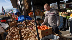 NC State Extension food safety researcher, Ben Chapman, checks out fresh produce at the State Farmers Market in Raleigh.